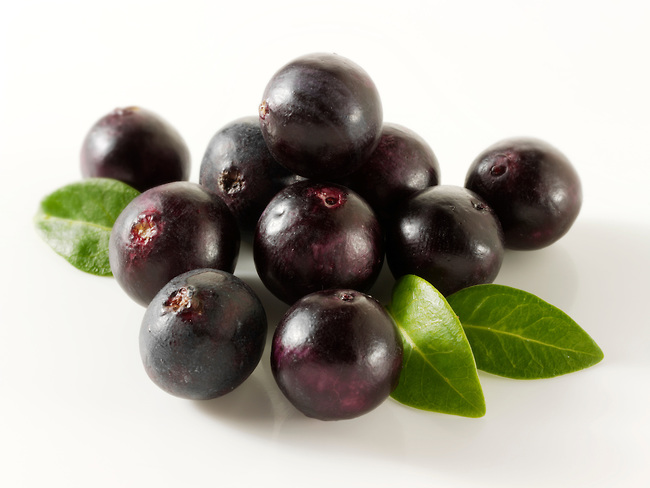Acai Berries anti oxident fruit  loose on a white background ready to cut out.